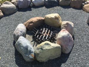 Boulder Firepit with gravel around it