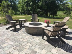 Paver Patio with Gas Firepit surrounded by chairs