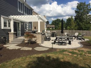 Paver patio with white Pergola with outdoor table and chairs