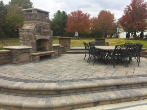 Raised Fireplace Paver Pation area with table and chairs