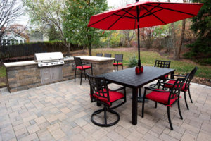 Outdoor kitchen and hardscape patio by Capehart Landscape & Design