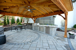 Outdoor kitchen and hardscape patio by Capehart Landscape & Design