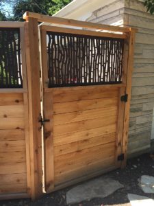 Capehart Landscape & Design decorative wooden door to backyard