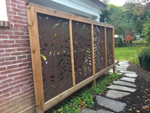 Capehart Landscape & Design Brown Staggered panels on side of brick house