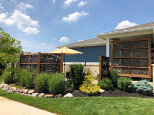 Capehart Landscape & Design Side View of Blue house with Brown Staggered panels